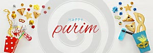 Purim celebration concept & x28;jewish carnival holiday& x29; over wooden white background. Banner.