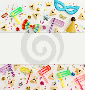 Purim celebration concept jewish carnival holiday over wooden white background. Top view, flat lay