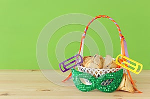 Purim celebration concept & x28;jewish carnival holiday& x29;. Traditional hamantaschen cookies in the basket over wooden table.