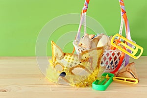 Purim celebration concept & x28;jewish carnival holiday& x29;. Traditional hamantaschen cookies in the basket over wooden table.