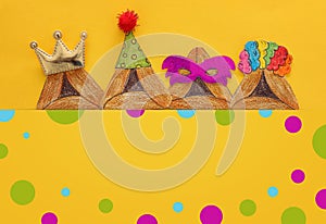 Purim celebration concept & x28;jewish carnival holiday& x29;. Traditional hamantash cookies cutted from paper and painted.