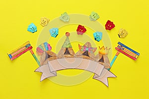 Purim celebration concept & x28;jewish carnival holiday& x29;. Traditional hamantash cookies cutted from paper and painted.
