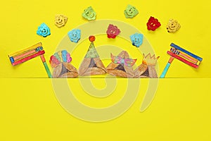 Purim celebration concept & x28;jewish carnival holiday& x29;. Traditional hamantash cookies cutted from paper and painted.