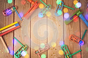 Purim holiday concept with noisemakers and bokeh lights on wooden background. photo