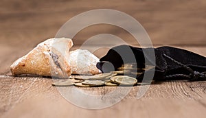 Purim holiday cookies, Ozne Haman in Hebrew. Haman's ears. With a bag of gold coins. Money for Purim