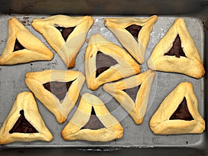 Purim jewish holiday cookies backed Hamentashen Ozen Haman in baking oven tray