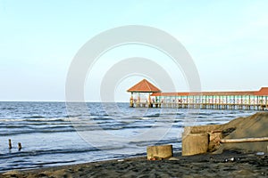 Purin Beach Pier in Tegal regency, Indonesia. photo