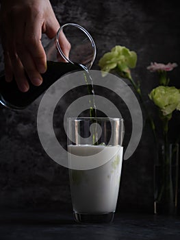 Puring tea in milk glass