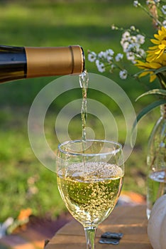 puring white wine outside in summer