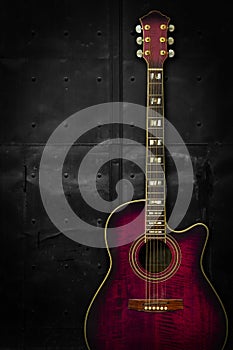 Purple acoustic guitar over dark background