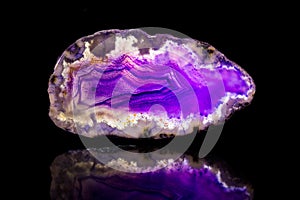 Purple agate slice, black background, healing stone and mineral photo