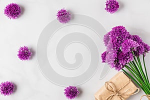 Purple alium flowers bouquet on white background with gift box. top view with copy space. flat lay