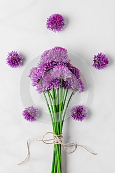 Purple alium flowers bouquet on white background. top view. flat lay. vertical orientation