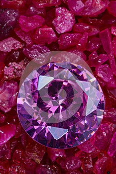 purple amethyst placed on a pile of raw granit gemstones