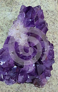 Purple amethyst stone isolated .Glossy violet texture of natural amethyst.