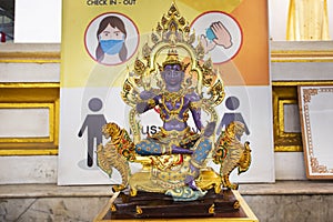 Purple ancient angel deity lord statue of Saturday for thai people travel visit respect praying blessing mystical myth holy at Wat