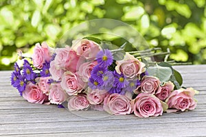 Purple aster and pink roses photo