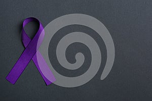 Purple awareness ribbon on black background, space for text