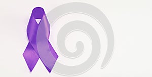 Purple awareness ribbon on white background. Cancer Fighting Challenges