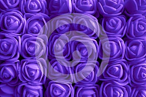 Purple background of artificial roses close-up, purple roses