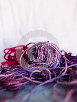 Purple balls thread on blue and white background