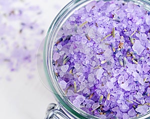 Purple bath salt foot soak wirh dry lavender, close up