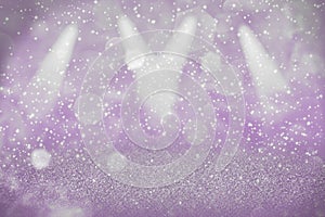 Purple beautiful glossy glitter lights defocused stage spotlights bokeh abstract background with sparks fly, festal mockup texture