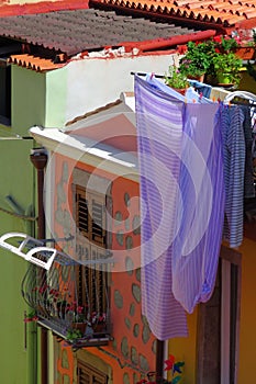 Purple bed sheets drying in the sun