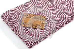 Purple and beige towel folded colorful textile for spa, beach, pool, light travel, healthy fashion and gifts. Tr