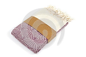 Purple and beige towel folded colorful textile for spa, beach, pool, light travel, healthy fashion and gifts. Tr