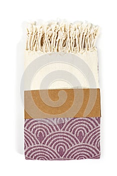 Purple and beige towel folded colorful textile for spa, beach, pool, light travel, healthy fashion and gifts. Tr