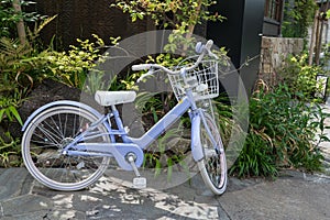 Purple bicycle by cafe building in Komachi Street, Kamakura, Japan