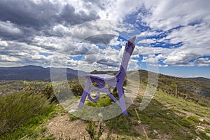 Purple big bench in the inland of Genoa in the countryside under a cloudy sky, Italy