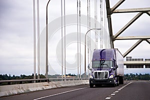 Purple big rig semi truck with dry van trailer for long haul car photo