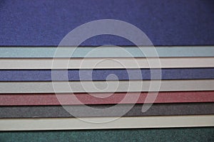 Purple blue grey teal mint background texture of colored paper on wooden table