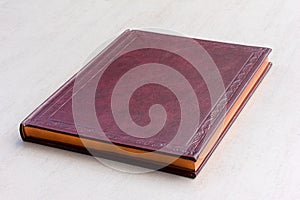 Purple book with gold pages on the gray background