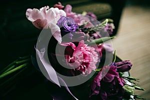 Purple bouquet of peonies lying on the table.  Bouquet for your sweetheart