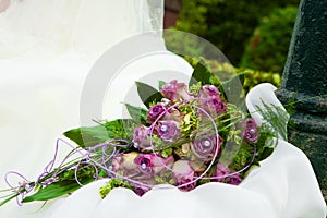 Purple bouquet on white dress