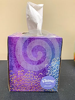 Purple Box of White Kleenex tissues side view