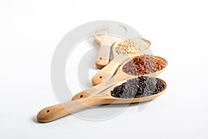 Purple-brown rice, jasmine red rice, jasmine brown rice, jasmine rice in wooden ladle on white background