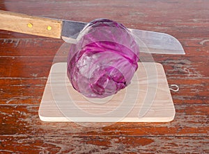 Purple cabbage on cutting boards on Wooden table .