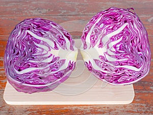 Purple cabbage on cutting boards on Wooden table .