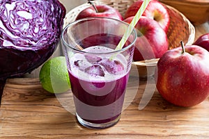 Purple cabbage juice in a glass on a wooden table