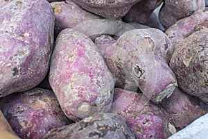 Purple Camote variant on display at a supermarket or marketplace. Sweet potatoes for sale photo