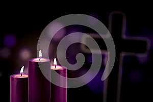 Purple candles with a cross symbol photo