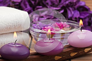 Purple candles and flowers in spa setting (1)