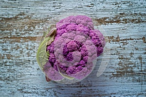 Purple color cauliflower vegetable on a gray table