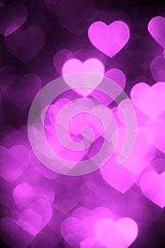 Purple color heart bokeh background photo. Abstract holiday, celebration backdrop.