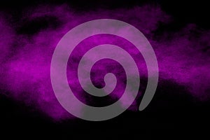 Purple Color powder explosion on black background