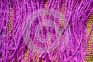 Purple Color Wool Detailed Threads Close Up on Dork Yellow Background Stock Photograph photo